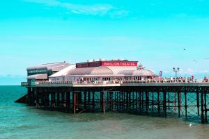 a pier with a seafood restaurant on the water at Stargazer Bell Tent in Northrepps +39 photos
