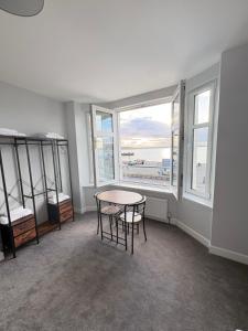 a room with a table and chairs and windows at Skips in Largs +36 photos
