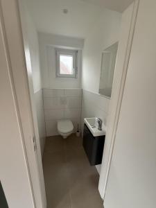 a small bathroom with a toilet and a sink at Cozy apartment in Vendenheim in Vendenheim