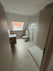 a bathroom with a shower and a toilet and a window at Cozy apartment in Vendenheim in Vendenheim