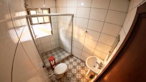 a small bathroom with a toilet and a sink at Nuh Hostel in Ouro Preto +27 photos
