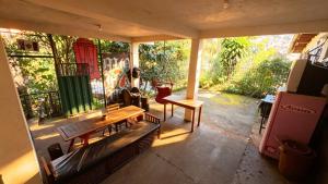 a screened in porch with a couch and a table at Nuh Hostel in Ouro Preto