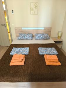 a bedroom with a bed with towels on it at Argisht complex apart 208 in Golden Sands +13 photos
