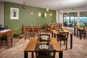 a dining room with wooden tables and chairs at Eremo della Gasprina in La Morra