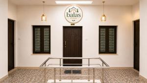a lobby with a glass table in front of a door at Bala's Rooms in Tirunelveli