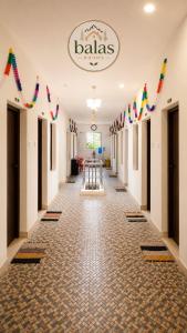 a hallway of a hall with flags on the walls at Bala's Rooms in Tirunelveli