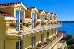 a building with flower boxes on balconies at All inclusive Villa Four Pearls in Trogir