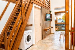 a laundry room with a washer and dryer at Le Cocon d'Ava - Bungalows & Spa in Saint-Paul