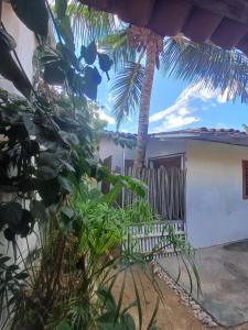a view of a house with a palm tree at Villa Moura Pousada in Amontada