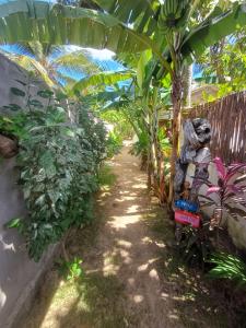 a statue of a gorilla on a train in a garden at Villa Moura Pousada in Amontada