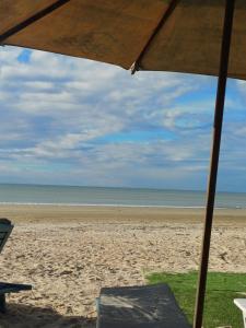 a view of a beach with an umbrella and the ocean at Villa Moura Pousada in Amontada +65 photos