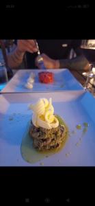 a dessert on a white plate on a table at Hostaria Floow in Avigliana