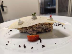 a piece of food on a white plate at Hostaria Floow in Avigliana