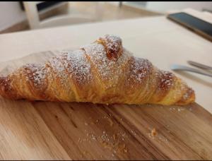 a pastry sitting on top of a wooden cutting board at Hostaria Floow in Avigliana +8 photos