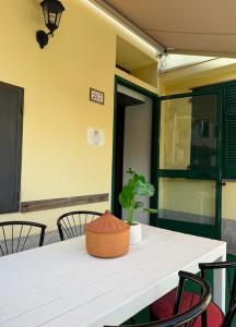a white table with a potted plant on top of it at Casa con Cortile, Barbecue e Parcheggio Privato in Sestri Levante +6 photos