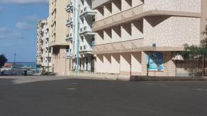 a building with a sign on the side of it at New Sandy Hotel in Marsa Matruh