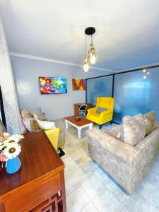 a living room with a couch and a table at Lilac cottage in Nairobi