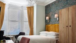 a bedroom with a bed and a window at The Rosedene in Llandudno