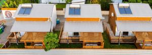 an aerial view of a building with chairs in front at Le Cocon d'Ava - Bungalows & Spa in Saint-Paul