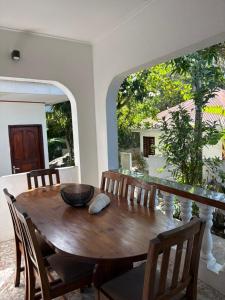 a dining room table with chairs and a bowl on it at Le Rocher De Machabee in Mahe