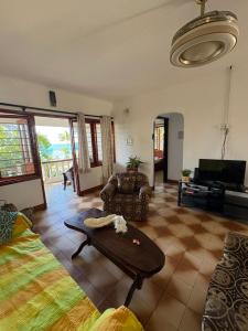 a living room with a couch and a table at Le Rocher De Machabee in Mahe
