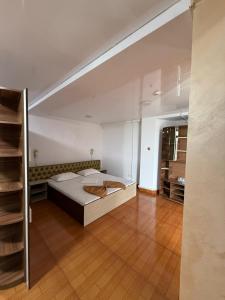 a large bedroom with a bed and a wooden floor at Asia Hotel in Târgu Jiu +17 photos
