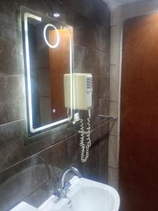 a phone on a wall above a sink in a bathroom at Rallis village in Akrata +16 photos