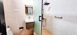 a bathroom with a shower and a toilet and a sink at First Choice Hotel in Accra