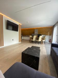 a living room with a couch and a table at Riverside A-frame in Borşa
