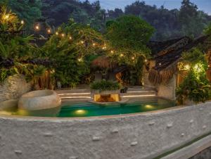 a swimming pool in the middle of a house at HAVAN Villas - Yogyakarta in Jarakan