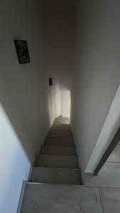 a staircase in a white room with a stair case at L'échappée du Verdon in Esparron-de-Verdon