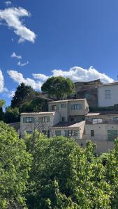 a group of buildings on a hill with trees at L'échappée du Verdon in Esparron-de-Verdon +142 photos