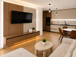 a living room with a television on a wall at Teslić CITY Apartment in Teslić