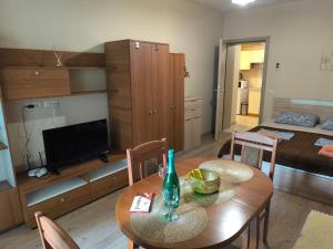 a living room with a table and a bedroom at Argisht complex apart 208 in Golden Sands