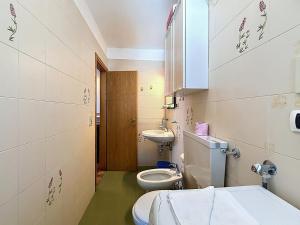 a bathroom with a toilet and a sink at Cesa Fraines - Apt 28 in Alba di Canazei