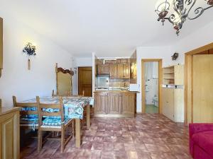 a kitchen and dining room with a table and chairs at Cesa Fraines - Apt 28 in Alba di Canazei