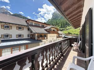 a balcony of a house with a view of the mountains at Cesa Fraines - Apt 28 in Alba di Canazei