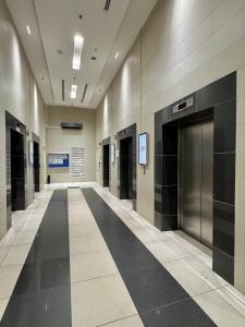 a hallway of a building with a elevator at Hushed Dorm KL in Kuala Lumpur
