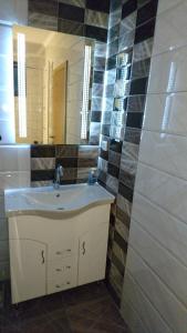 a bathroom with a sink and a mirror at LuFi Penthouse Apartment in Zlatibor