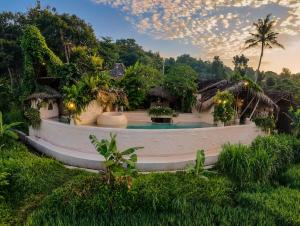 a resort with a pool in the middle of a yard at HAVAN Villas - Yogyakarta in Jarakan