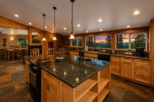 a large kitchen with wooden cabinets and a large island at River Heights Home cabin in Leavenworth
