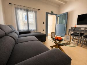 a living room with a couch and a glass table at Seaside Nest in Kythira