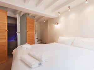 a bedroom with a white bed with towels on it at Ferrydown in Salcombe +2 photos