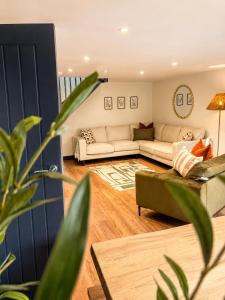 a living room with a couch and a table at Lilac Cottage in Barnard Castle