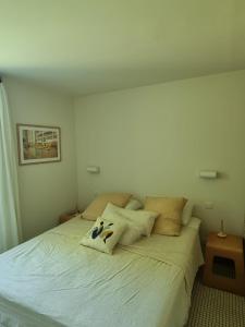 a bedroom with a bed with two pillows on it at Maison Caramel in Condorcet