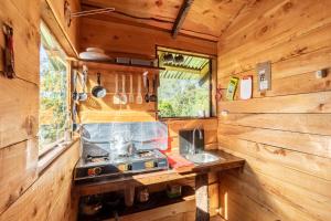 a kitchen with a stove and a sink in a cabin at Jaulares Glamping in Alaska +36 photos