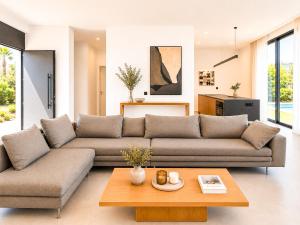 a living room with a couch and a coffee table at Miguel Luxury Beach Front Villa in Fánai