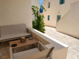 a balcony with a couch and a table at Seaside Nest in Kythira +2 photos