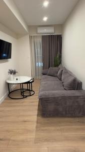 a bedroom with a bed and a table in it at Sweet Nest in Paralia Katerinis