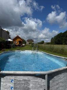 a large swimming pool in a yard at Islandzka chatka- Jacuzzi i sauna w cenie in Mżyki